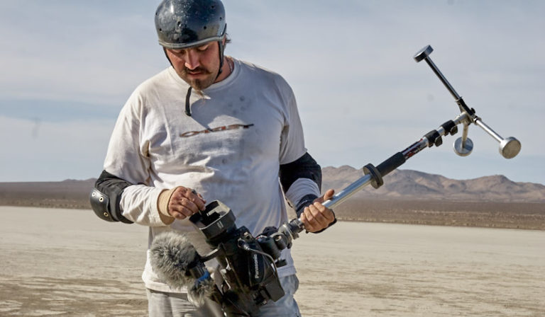 The Director dealing with the impossible mission of keeping a lens clean, in the desert dust…